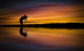 Silhouette Photographer take photo beautiful seascape at sunset