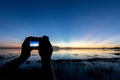 Silhouette of Photographer take photo with mirorless camera.People side view,Young traveler sightseeing with beautiful sunset Royalty Free Stock Photo