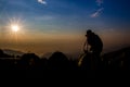 silhouette of photographer taking photo at sunrise in a beautiful fog landscape below Royalty Free Stock Photo