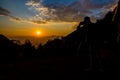 silhouette of photographer taking photo at sunrise in a beautiful fog landscape below Royalty Free Stock Photo