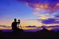 Silhouette of photographer taking photo at sunset beside the sea Royalty Free Stock Photo