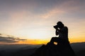 Silhouette of a photographer on top of a mountain at sunset Royalty Free Stock Photo