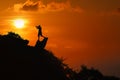 Silhouette of photographer on top of mountain at sunset red sky Royalty Free Stock Photo