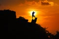 Silhouette of photographer on top of mountain at sunset red sky Royalty Free Stock Photo