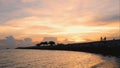 Silhouette picture of happy family walking on the bridge over the beach