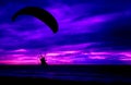 Silhouette pilot paramotor sunset sea background