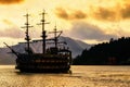 Silhouette Pirate ship an torii gate at lake Ashi