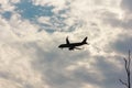 Silhouette plane flying in cloud of the clouds