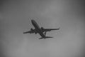 Silhouette of plane in grey sky. Passenger plane flies high in sky, flight. International flights, delivery