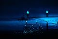 Silhouette of plane landing, runway lights, blue effect Royalty Free Stock Photo