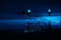 Silhouette of plane landing, runway lights, blue effect Royalty Free Stock Photo