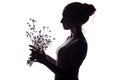 Silhouette pof a beautiful girl with a bouquet of dry dandelions, the face profile of a dreamy young woman on a white isolated Royalty Free Stock Photo