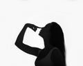 Silhouette portrait of a beautiful caucasian girl, white background, studio photo. Close-up and copy space. Disappointment concept