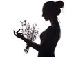 Silhouette profile of a beautiful girl with a bouquet of dried flowers on a white isolated background Royalty Free Stock Photo