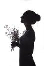 Silhouette portrait of a beautiful girl with a bouquet of with dandelions on a white isolated background Royalty Free Stock Photo