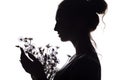 Silhouette portrait of a girl with a bouquet of dry flowers, face profile of a dreamy young woman on a white isolated background Royalty Free Stock Photo