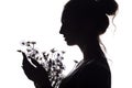 Silhouette portrait of a girl with a bouquet of dry flowers, face profile of a dreamy young woman on a white isolated background