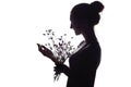 Silhouette portrait of a beautiful girl with a bouquet of dry dandelions, the face profile of a dreamy young woman on a white Royalty Free Stock Photo