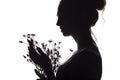 Silhouette portrait of a girl with a bouquet of dry flowers, face profile of a dreamy young woman on a white isolated background Royalty Free Stock Photo