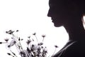 Silhouette portrait of a girl with a bouquet of dry flowers, face profile of a dreamy young woman on a white isolated background Royalty Free Stock Photo