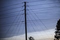 Silhouette of power lines against a cloudy blue sky background Royalty Free Stock Photo