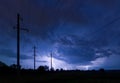 Silhouette of power lines on thunderstorm with lightnings background Royalty Free Stock Photo