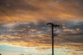 Silhouette of a power lines in Lightning Ridge back lit by a sunset