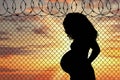 Silhouette of a pregnant refugee