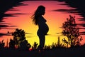 Silhouette of a pregnant woman against the background of the sunset Royalty Free Stock Photo