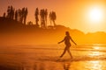 Silhouette of pregnant woman at beach with bright sunrise or sunset tones Royalty Free Stock Photo