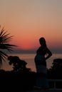 Silhouette of a pregnant woman on the beach at sunset Royalty Free Stock Photo