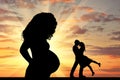 Silhouette a pregnant woman and loving couple