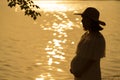 Silhouette of pregnant woman at a lake Royalty Free Stock Photo