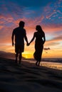 Silhouette of a pregnant woman walking hand in hand with her husband on the beach at sunset. Royalty Free Stock Photo