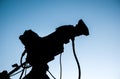 Silhouette of the professional video camera set on the tripod with blue sky Royalty Free Stock Photo