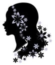 Silhouette profile of a cute lady s head. The girl has long beautiful hair, decorated with flowers. Suitable for logo, advertising Royalty Free Stock Photo