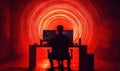 Silhouette of Programmer Working at Desk with Red Light Background and Code on Screens