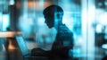 Silhouette of a programmer working on a laptop in a high-tech environment with digital code floating around, focusing on