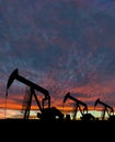 Silhouette of pumpjack against a dramatic sky Royalty Free Stock Photo