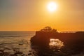 Silhouette of Pura Batu Bolong in golden sunset it the traditional Balinese temple located on a rocky, in the Tanah Lot area, Bali Royalty Free Stock Photo