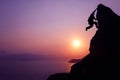 Silhouette purple of man climbing rock, Photographer on the mountain at sunrise Royalty Free Stock Photo