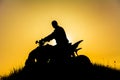 Silhouette of quad bike driver on the mountain