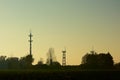 Silhouette of radio tower and watchtowers of an airport in evening light Royalty Free Stock Photo