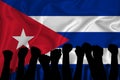 Silhouette of raised arms and clenched fists on the background of the flag of cuba. The concept of power, conflict. With place