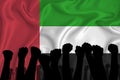 Silhouette of raised arms and clenched fists on the background of the flag of United Arab Emirates. The concept of power, power,