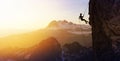 Silhouette Rappelling from Cliff