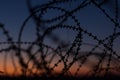 Silhouette Razor Barbed Tape Wire And light in the evening Royalty Free Stock Photo