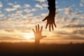 Silhouette of reaching, giving a helping hand, hope and support each other Royalty Free Stock Photo
