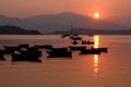 Silhouette of recreational boat, mountain with reflection at sun