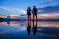 Silhouette and reflection of romantic boy and girl friends holding hands and enjoying sunset at Water front at Western District Royalty Free Stock Photo